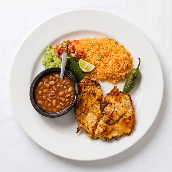 Grilled chicken with rice, beans, guacamole, pico de gallo, lime, and two jalapeños.